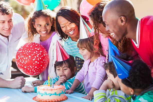 istock Girl blowing out birthday candles 509757807