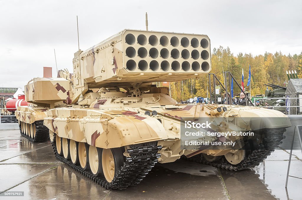 Heavy fire-throwing TOS-1A system. Russia Nizhniy Tagil, Russia - September 26. 2013: Visitors examine military equipment on exhibition range. TOS-1A system fighting vehicle (Buratino). Russia Arms Expo-2013 exhibition Activity Stock Photo