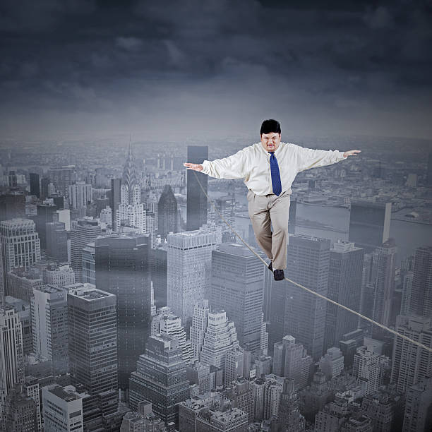 istock Fat businessman walking on the rope 509758517