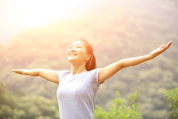 istock cheering hiking woman open arms at mountain peak 509758717