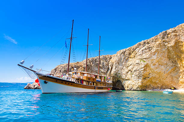 istock Vintage sailing boat in bay. 509759363