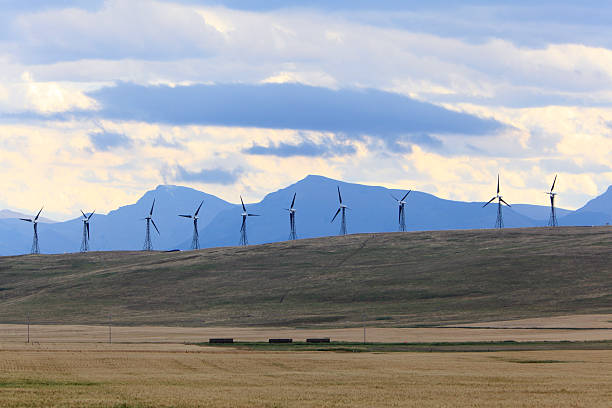 istock Row Of Wind Turbines With Mountains,Prairie And Sky 509759457