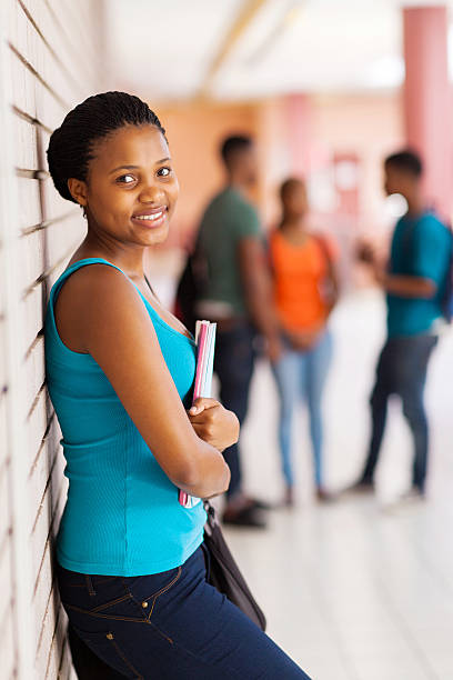 istock african female student leaning against a wall 509778855