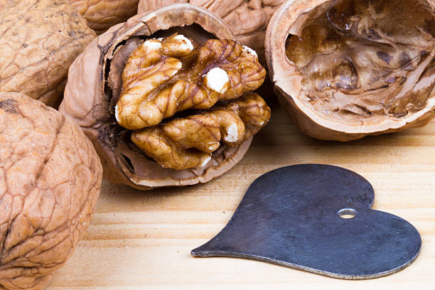 walnut kernel on rustic wooden table with a heart stock photo