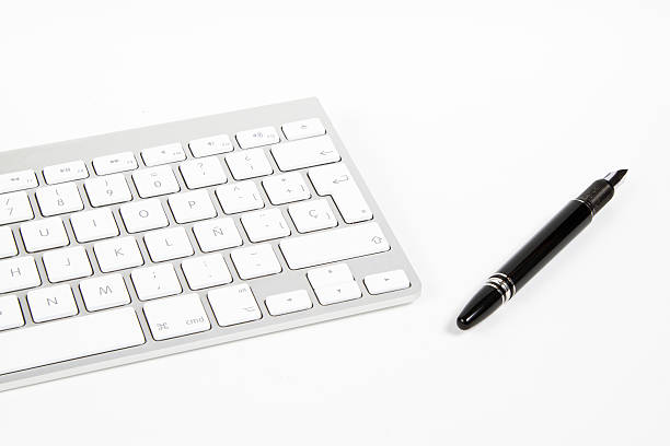 keyboard and fountain pen stock photo