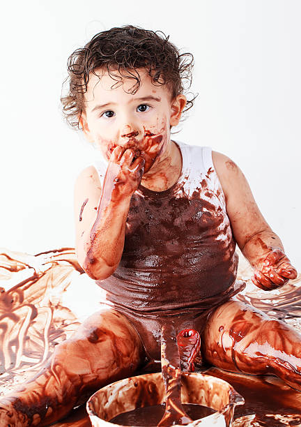 Chocolate Baby Chocolate Baby tasting cherry eating human face stock pictures, royalty-free photos & images