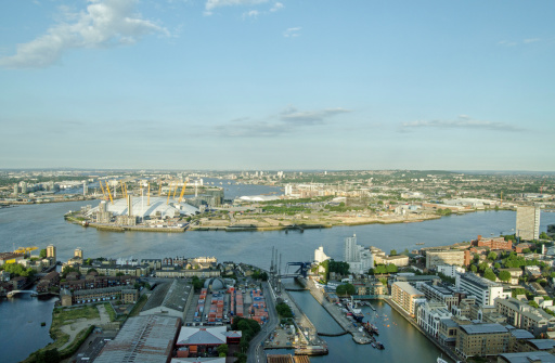 View from a tall building of the meandering River Thames as it passes between North Greenwich and Tower Hamlets in East London.