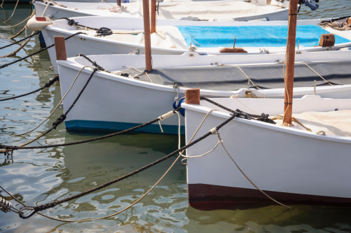 Traditional sailboats (llauts) moored, no registration numbers, Majorca. Mallorca, Balearic islands, Spain.