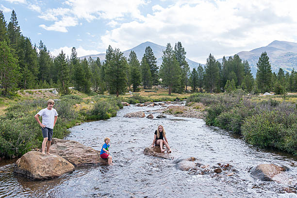 istock Three children sit on rocks in River Yosemite California 509781825