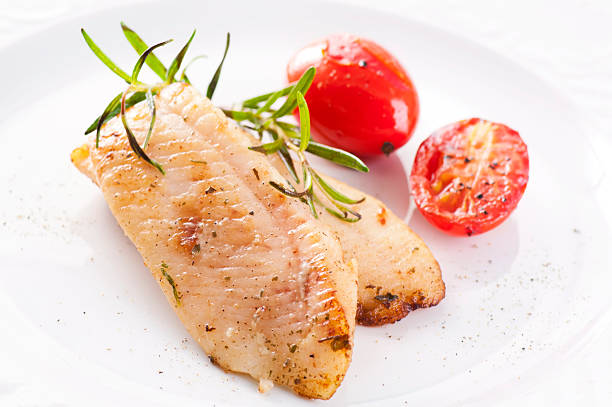 Fried Fish Fillet with Tomatoes stock photo