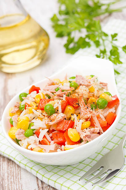 istock salad with corn, green peas, rice, red pepper and tuna 509784487