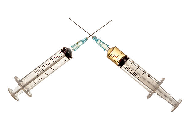 Two crossed syringes on isolated white stock photo