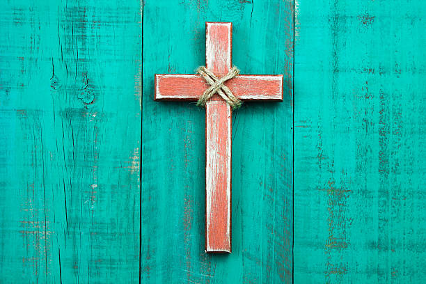 Wood cross hanging on rustic door