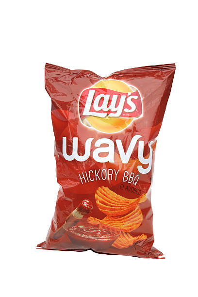 Lay's Wavy Hickory BBQ potato chips on white background West Palm Beach, USA - January 31, 2016: A package of Lay's Wavy Hickory BBQ potato chips on a white background. Lay's potato chips are made by Frito Lay Inc.  lays potato chips stock pictures, royalty-free photos & images