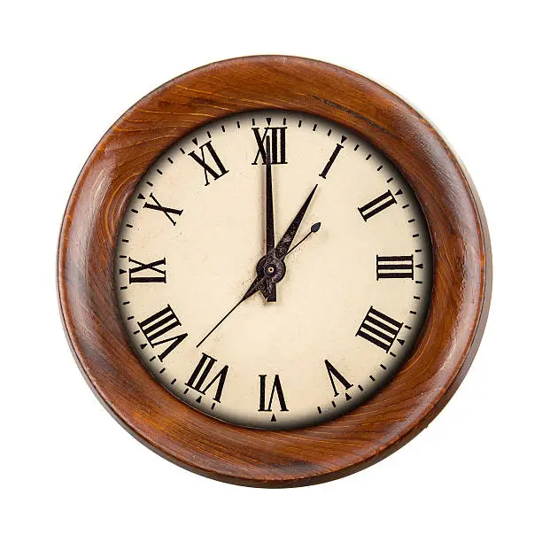 Vintage clockface showing one o'clock in wooden frame isolated over white