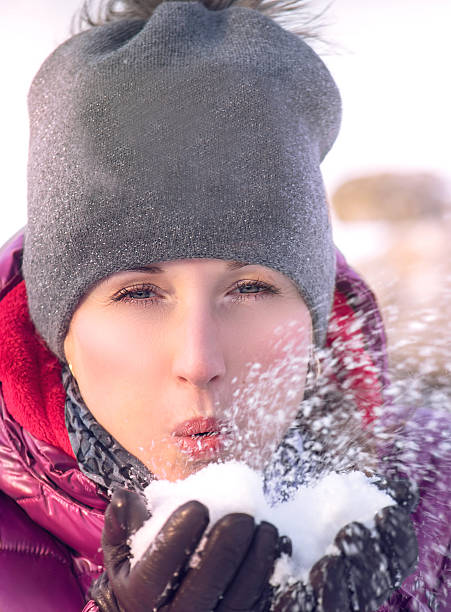 istock Pretty young woman blowing snow 509792624