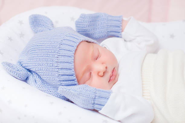 istock Sleeping little baby wearing knitted hat with ears and mittens 509792828