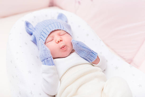 istock Little baby wearing knitted blue hat with ears and mittens 509792966