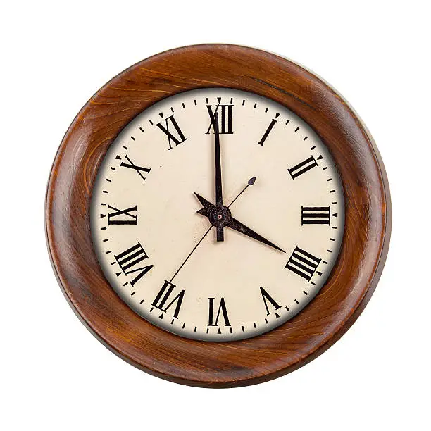 Vintage clockface showing four o'clock in wooden frame isolated over white