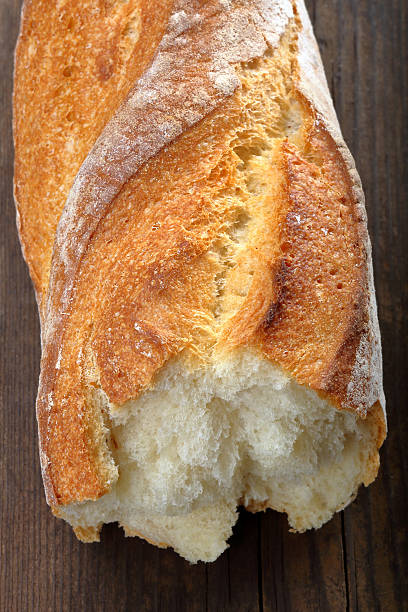 istock Fresh French baguette on wooden background 509794164