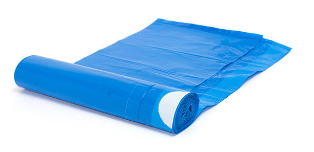 istock Roll of blue plastic garbage bags isolated on white 509795158