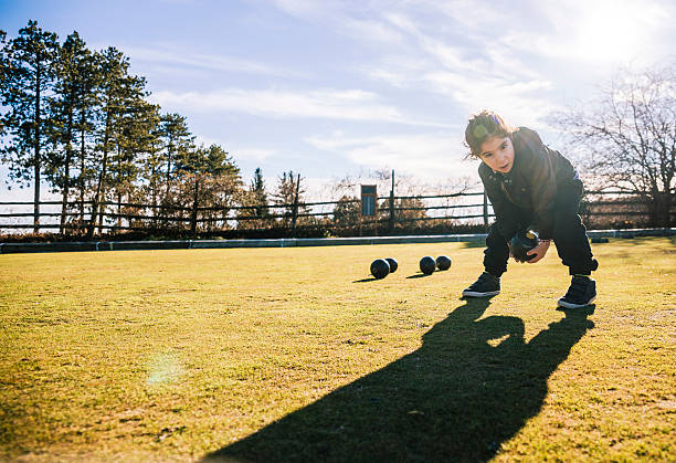istock Little boy plays bowls at the lawn 509802852