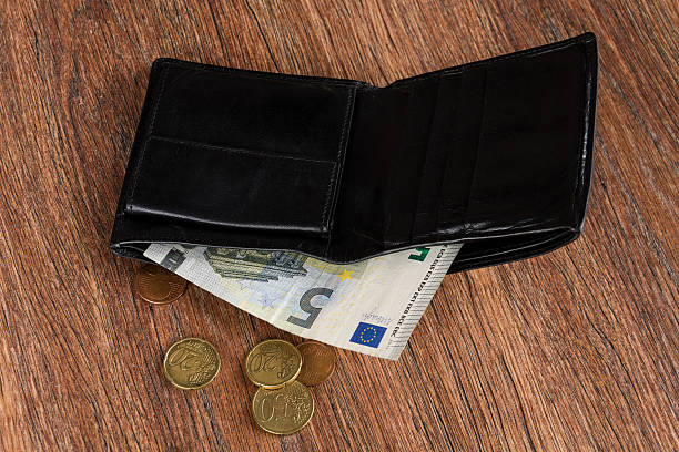 istock Concept: poverty. Leather wallet with five euro and euro cents. 509803616