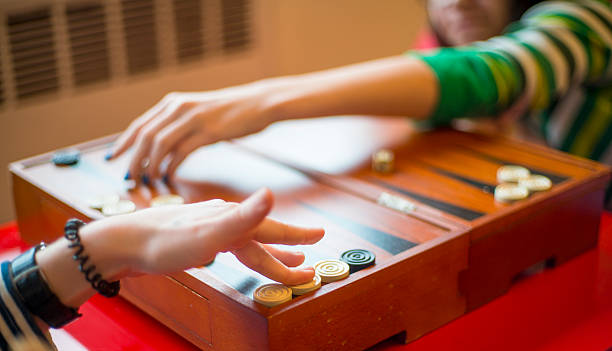 istock Two teenager girls playing backgammon 509803640