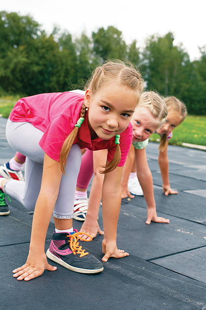istock Three schoolgirls are at the start on the treadmill 509803855