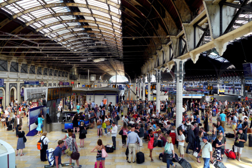 crowds wait for their train at paddington station, london, england