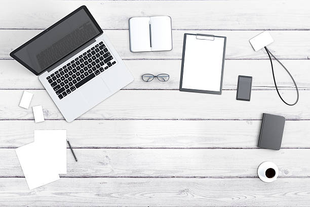 istock White wooden desk with laptop and copyspace 509805764