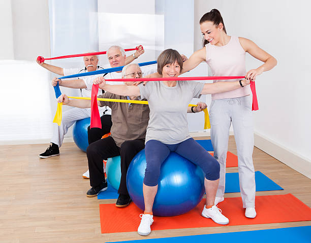 istock Trainer Assisting Senior People At Gym 509805883
