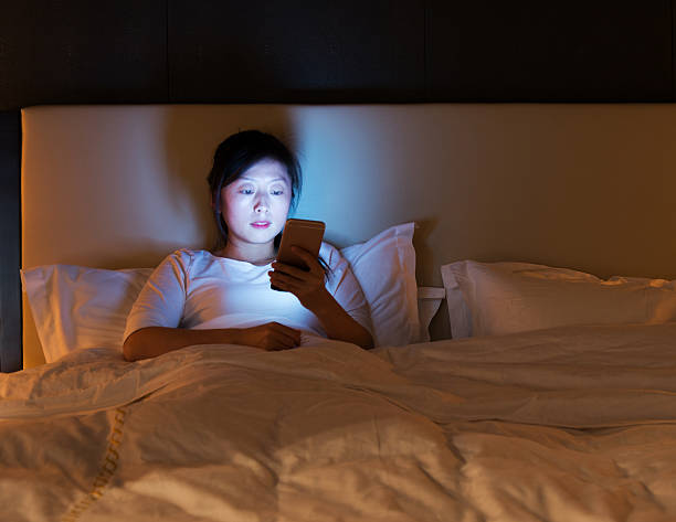 istock Woman using a smart phone in bed 509812956
