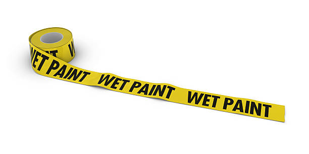 istock WET PAINT Tape Roll unrolled across white floor 509813502