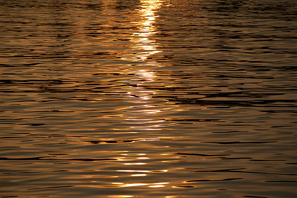 istock Golden ray of light over water 509813852