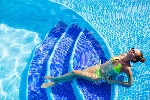 istock Beautiful woman with sexy body by the pool 509817708