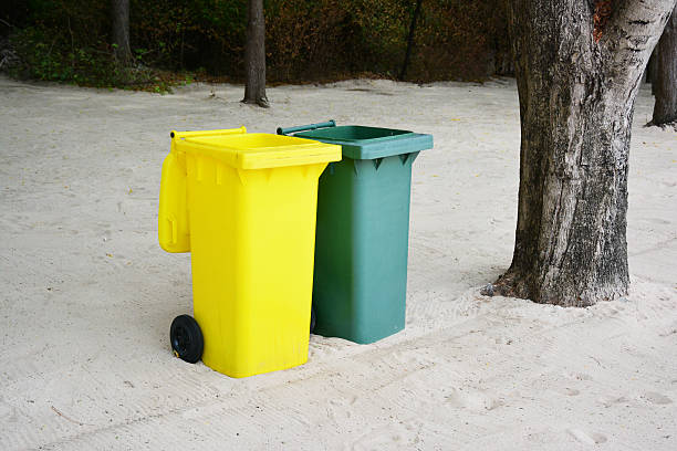 istock Yellow, Green bins public trash on sand. 509825411