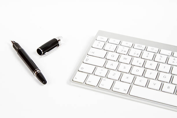 keyboard and fountain pen stock photo