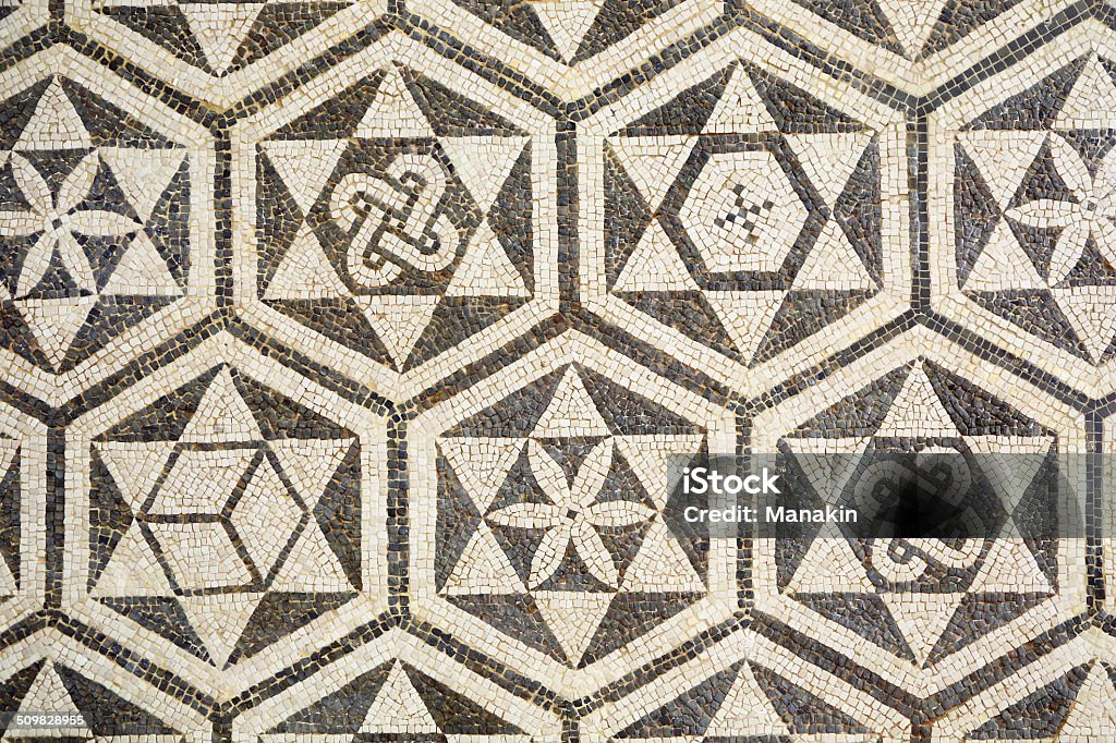 Fragment of ancient roman mosaic in Carmona, Spain Fragment of ancient roman mosaic forming a texture in Carmona, Spain. The mosaic is hung on a wall in a public space Carmona Stock Photo