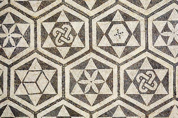 Fragment of ancient roman mosaic in Carmona, Spain Fragment of ancient roman mosaic forming a texture in Carmona, Spain. The mosaic is hung on a wall in a public space carmona stock pictures, royalty-free photos & images