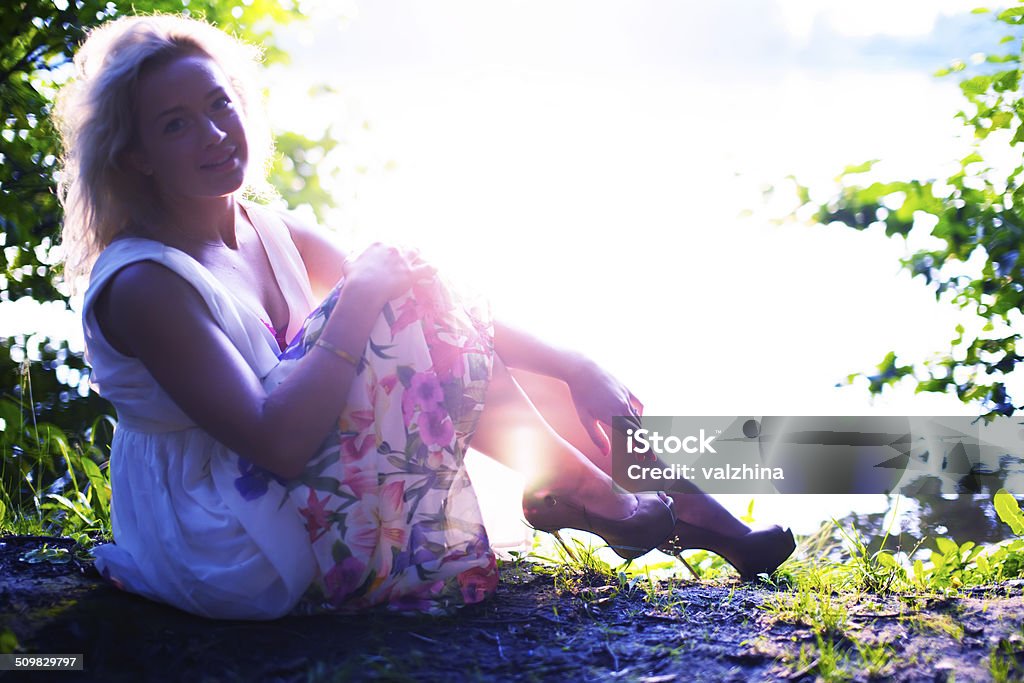 portrait of beautiful blond woman enjoying warm summer sunset Adult Stock Photo