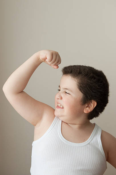 istock boy  kid  strength  training muscle  sport    powerful exercise fat  vest 509842914