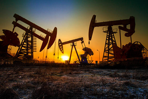 pumping unit in sun pumping unit in sun natural gas extraction stock pictures, royalty-free photos & images