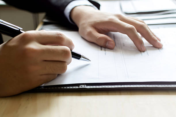 istock Human Hand Signing on Formal Paper at the workplace 509845610