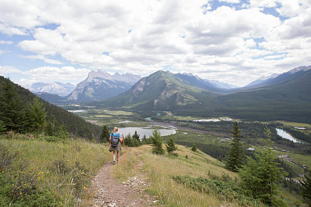 istock Female hiker descends mountain path towards valley 509845859