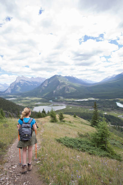 istock Female hiker descends mountain path towards valley 509845895