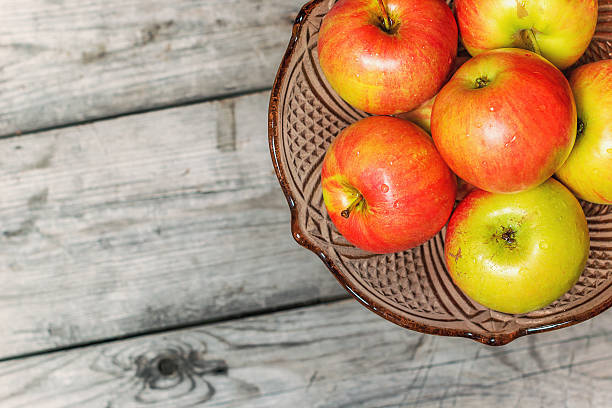 istock Fresh apples in decorative vase for fruit on wooden table 509849546