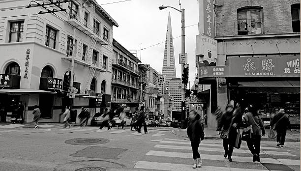 San Francisco, California, USA - May 18, 2015: Shoppers in Chinatown with Transamerica Pyramid in the background in San Francisco, CA. It's the oldest Chinatown in North America and the largest Chinese community outside Asia.