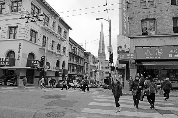 San Francisco, California, USA - May 18, 2015: Chinese people and Transamerica Pyramid as seen from Chinatown in San Francisco, CA. It's the oldest Chinatown in North America and the largest Chinese community outside Asia.
