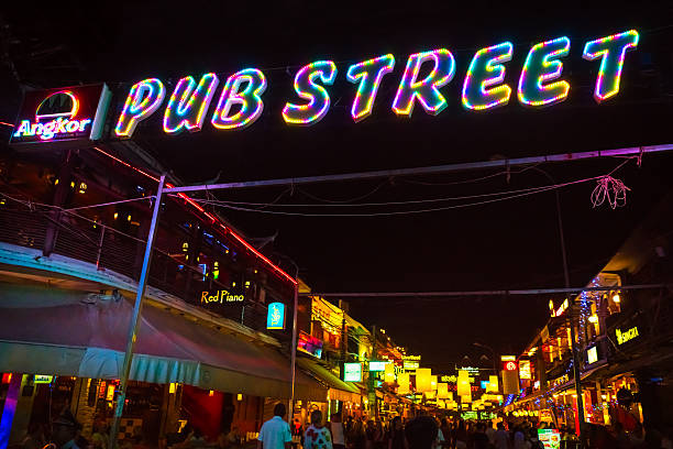 New Orleans, Louisiana, USA United States of America - March 2, 2022: Blurred motion of tourists walking on a street in New Orleans' French Quarter at night during Mardi Gras celebrations, with colorful neon signs and lights creating a vibrant and festive atmosphere